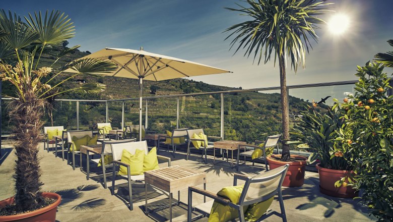 Steigenberger Krems, Sky Garden, © Steigenberger Hotel and Spa, Andreas Hofer Terrace of the Steigenberger Krems with parasols and plants.