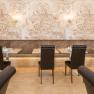 An elegant restaurant with laid tables and stylish wall decorations.