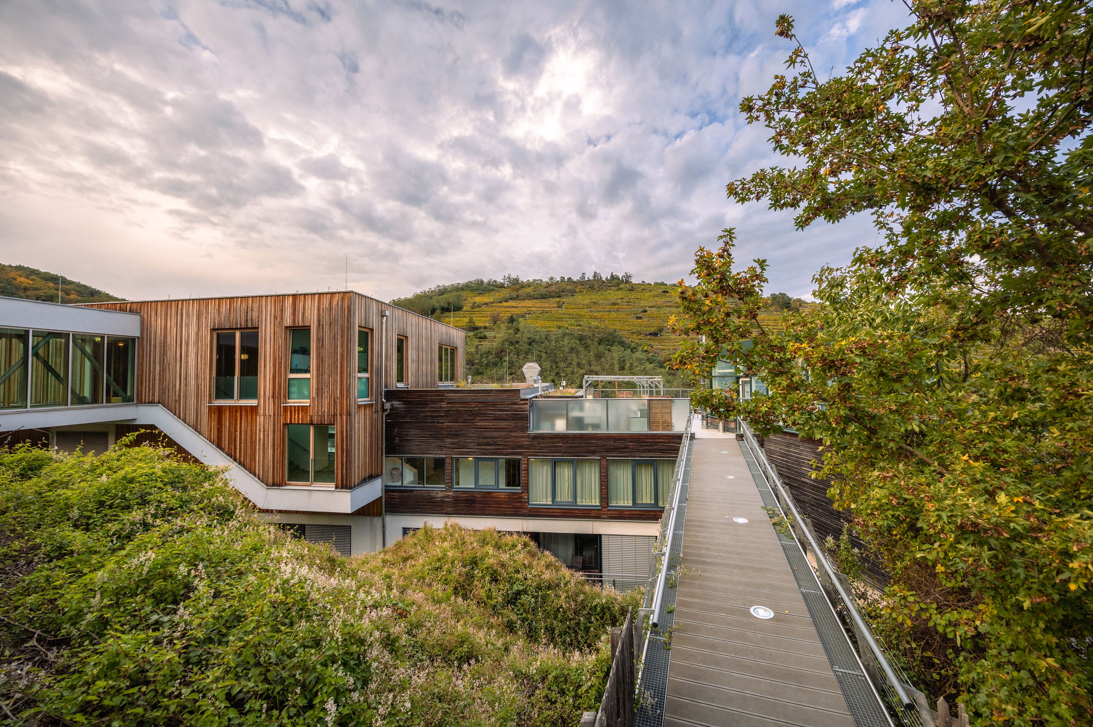 Steigenberger Hotel & Spa in Krems mit Holzfassade und umliegender Natur.
