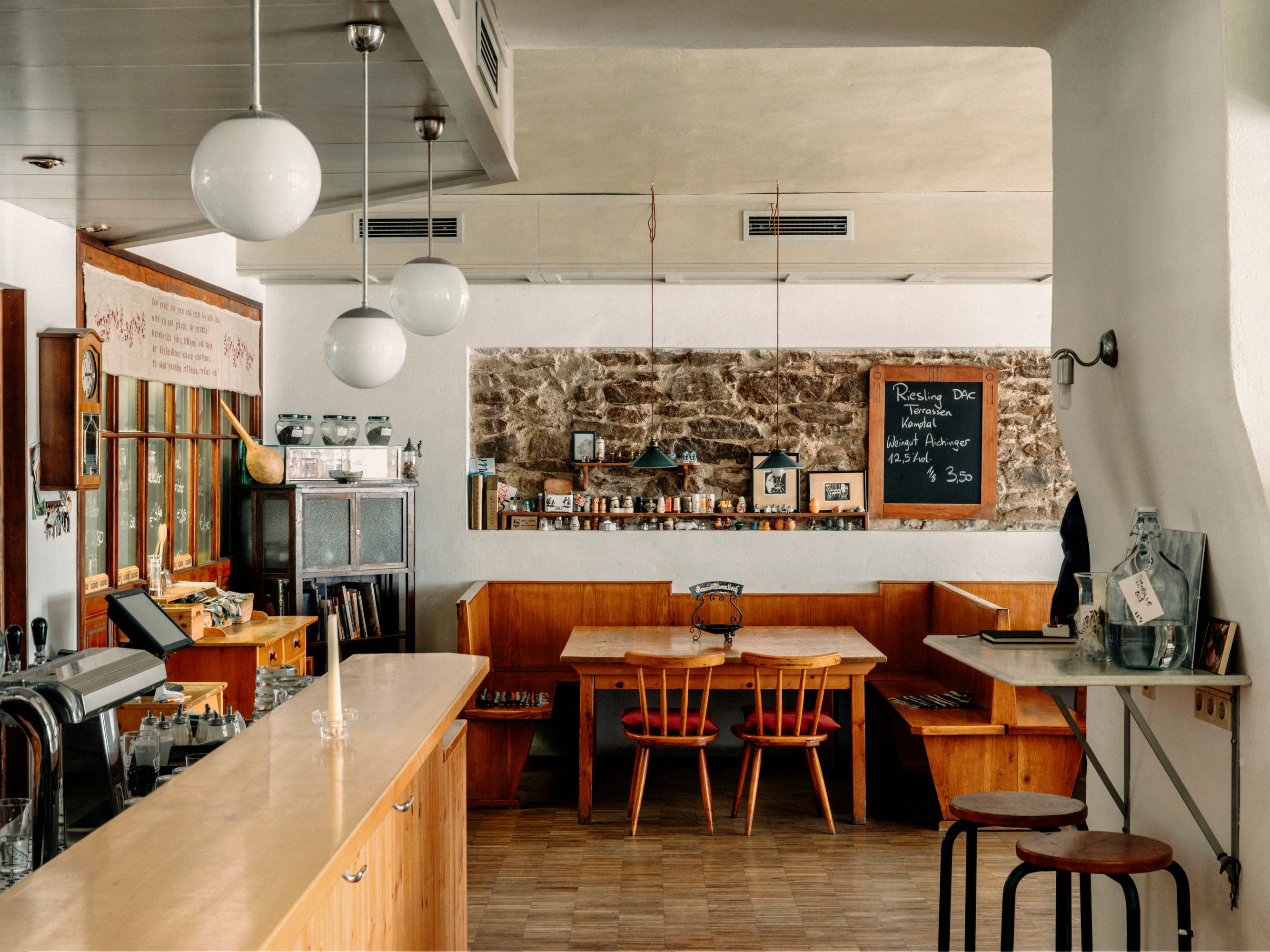 Gemütliches Café mit Holzmöbeln und Kreidetafel an der Wand.