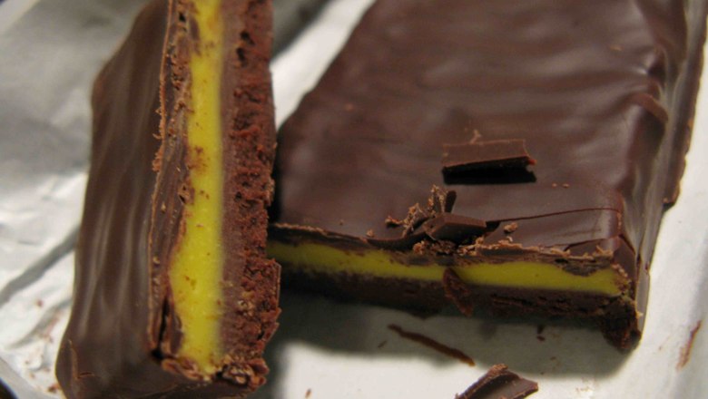 Close-up of a sliced chocolate bar with yellow filling.