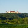 Göttweig Benedictine Abbey on a hill with a green landscape in the foreground.
