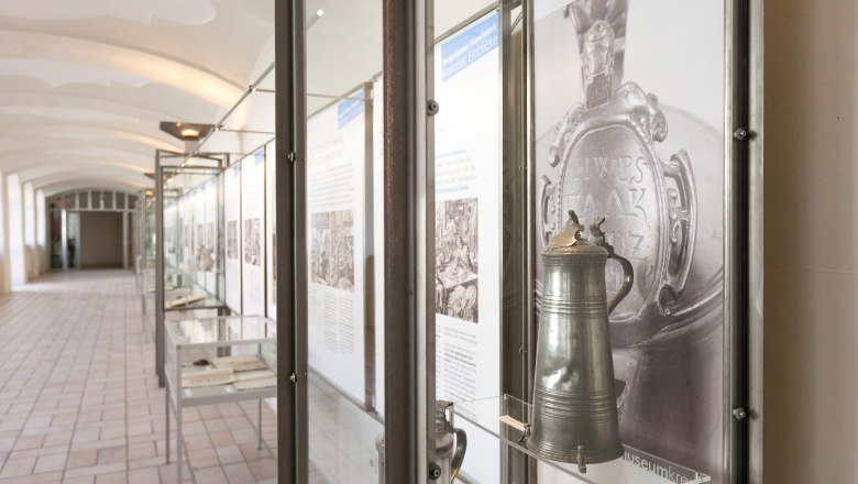 Exhibition in the Krems Museum with historical objects in glass cases.