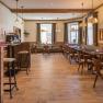 Cozy breakfast area with wooden furniture and large windows.