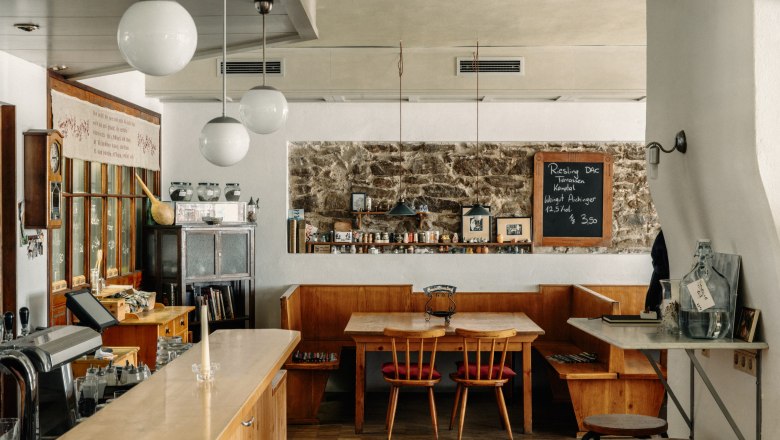 Cozy caf&eacute; with wooden furniture and chalkboard on the wall.