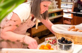Frau bereitet belegte Br&ouml;tchen vor