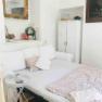 Cozy sleeping area with white sofa, side table and decorative elements.