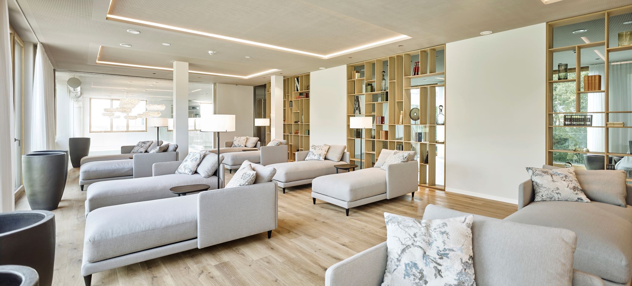 Moderner Lounge-Bereich im Spa mit grauen Sofas und Regalen im Steigenberger Krems.